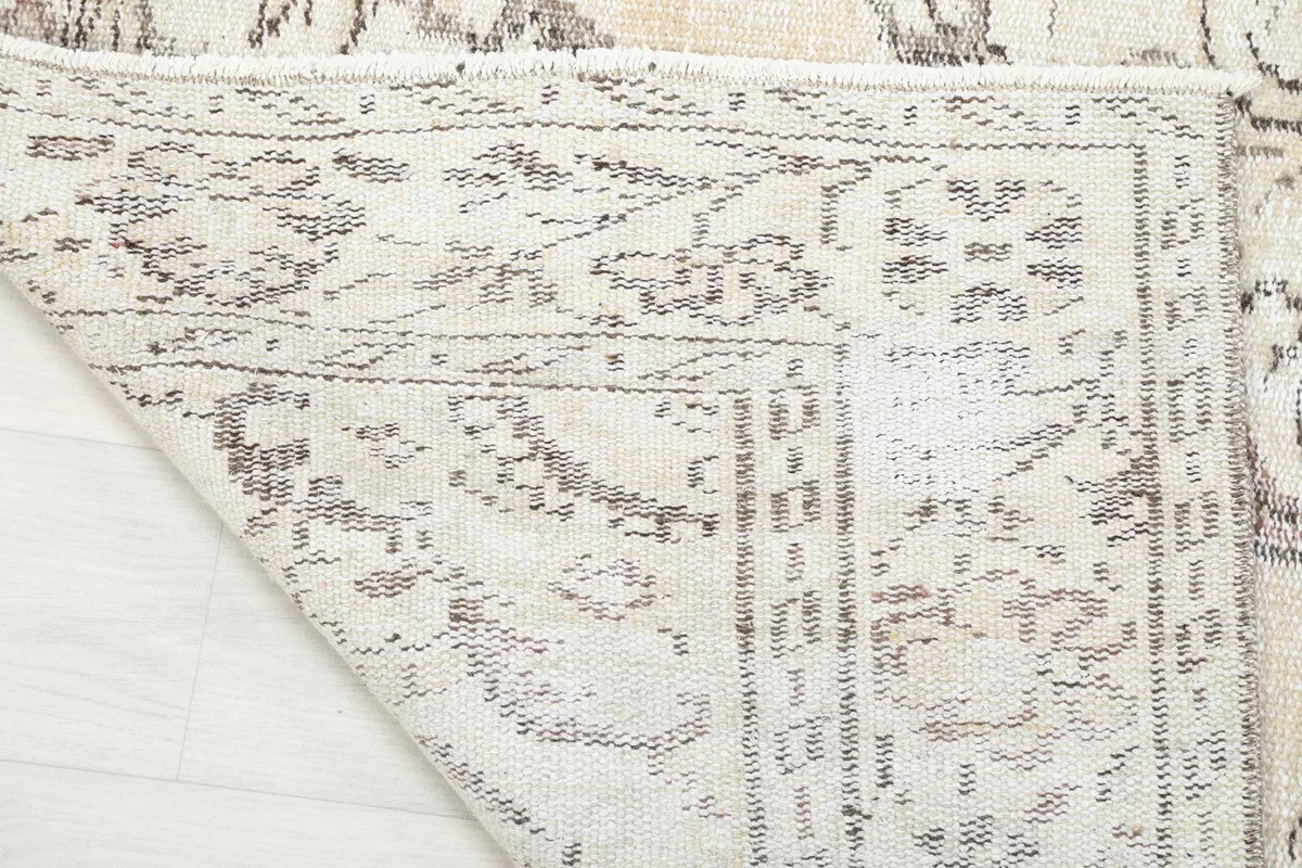 Underside view of the rug, showing the intricate hand-knotted cotton foundation