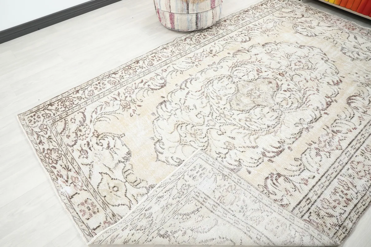 Corner of the rug folded back, revealing the reverse side of the hand-knotted construction