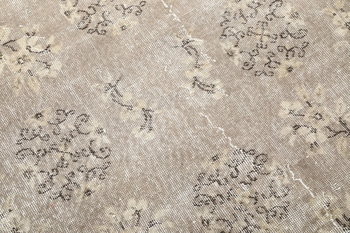 Texture and detail of the low wool pile, showing vintage wear and color variations