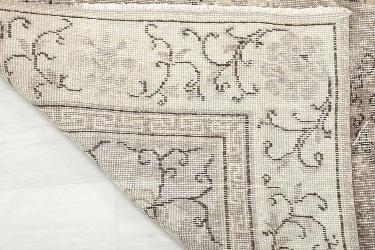Close-up of the rug's back, displaying the hand-knotted construction and foundation details