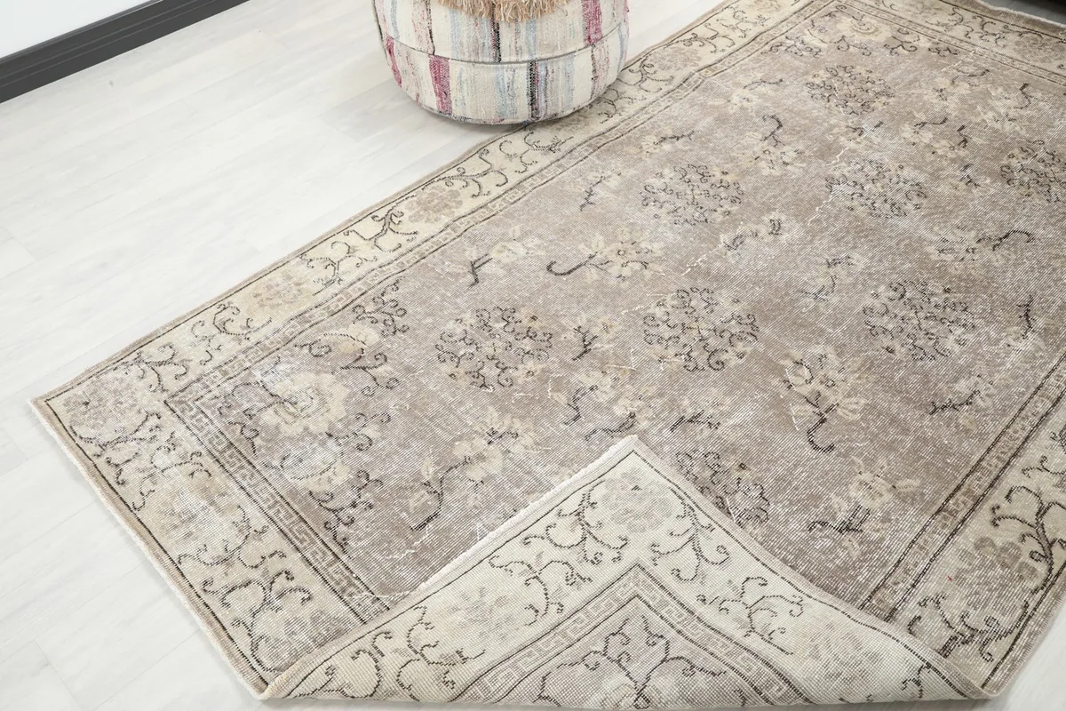 Rug corner folded back to reveal the cotton foundation and the reverse side of the knots