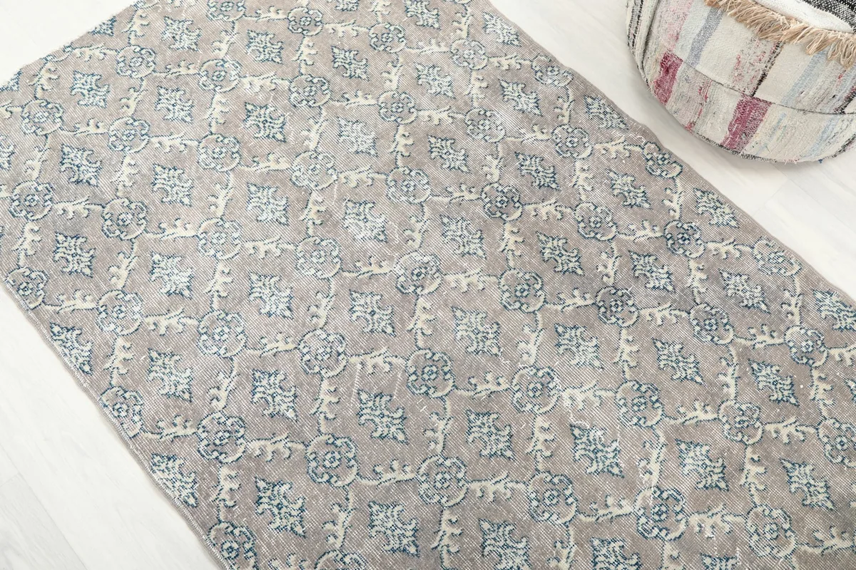 Angled view of the rug's surface, showing the repeating geometric motifs
