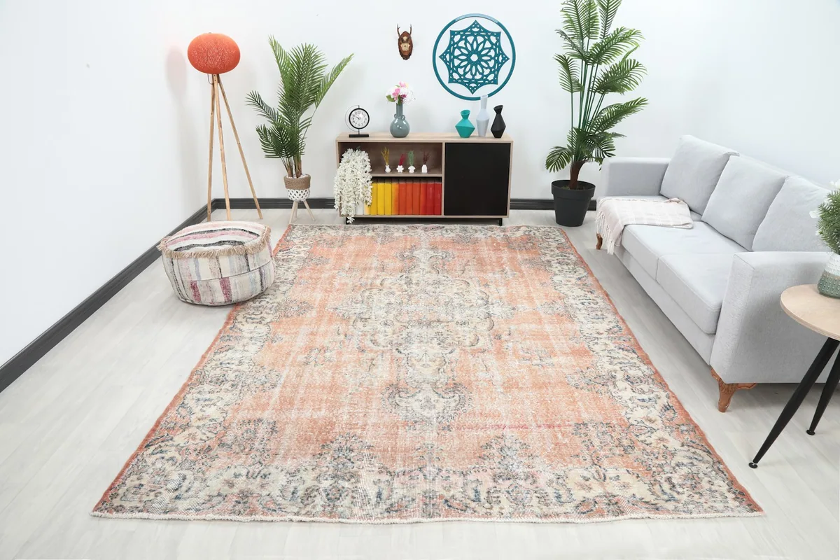 Wide angle view of the rust and ivory vintage rug placed in a modern living room setting.