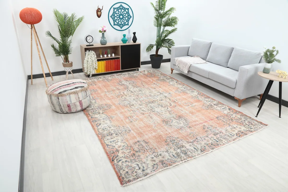 Angled view of the vintage Anatolian rug in a living room, showing its scale and color in context.