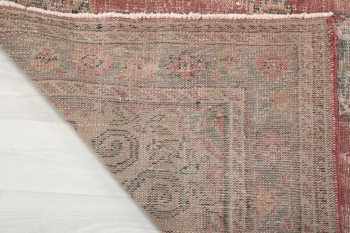 Detailed view of the back of the rug, revealing the woven cotton foundation and knotting
