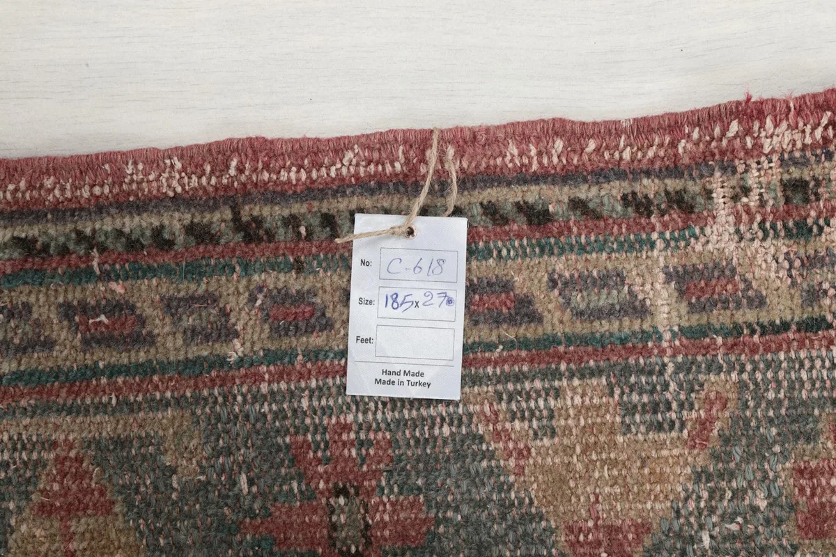 Detail of the rug's edge with a product tag showing size and origin information