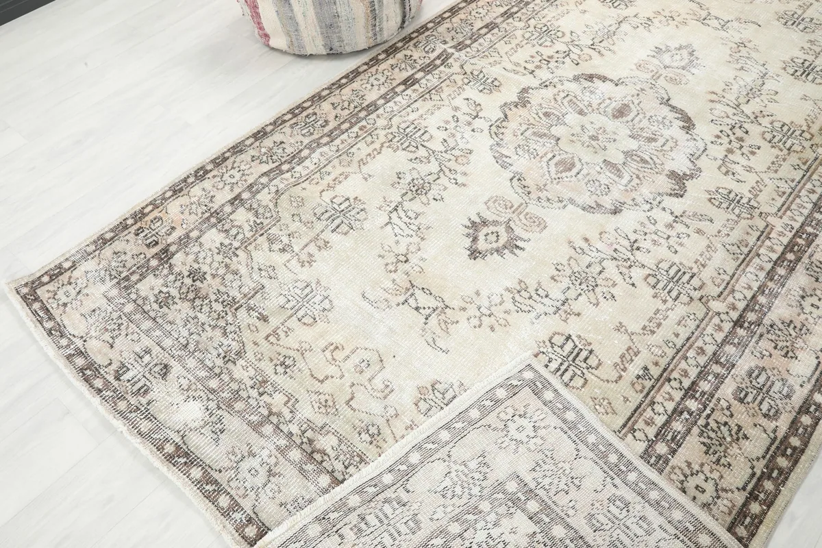 Rug partially folded to show the flexibility and texture of the hand-knotted wool pile
