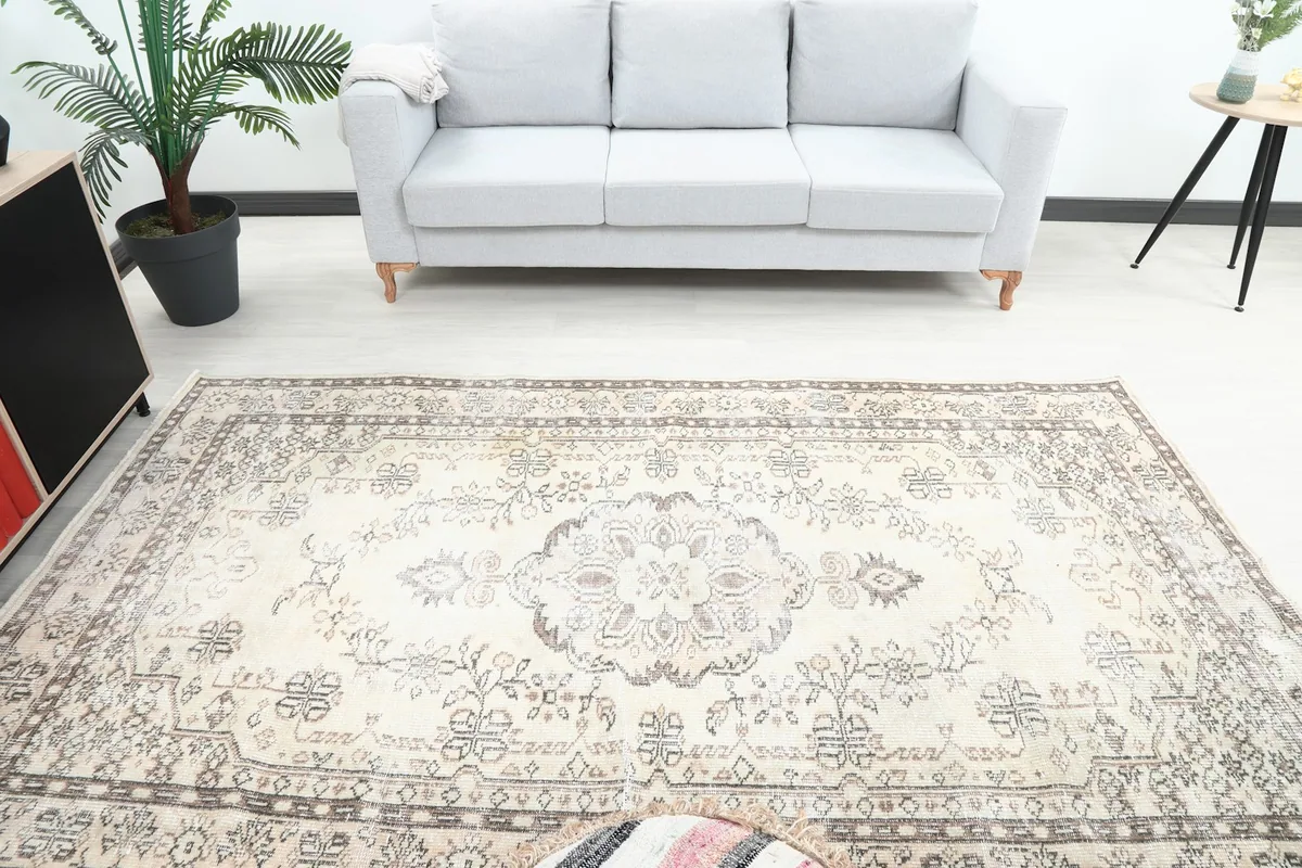 Overhead view of the vintage rug in a room, highlighting the central medallion and surrounding decor