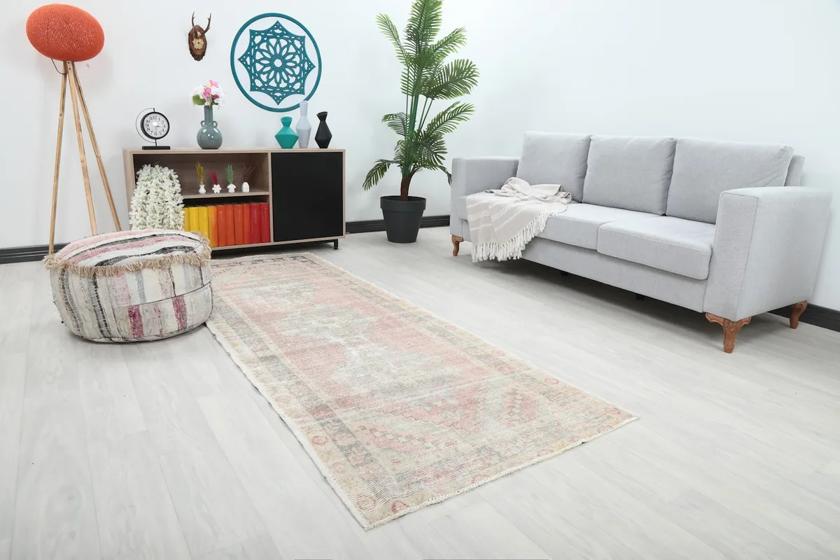 Angled view of the vintage runner rug in a room, showing its length and placement.