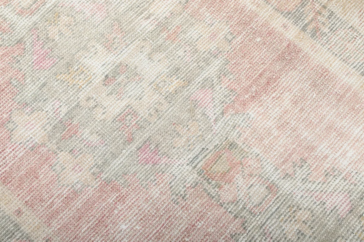 Detailed view of the low wool pile, showing the hand-knotted texture and color variations.