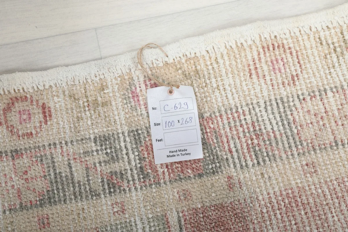 Close-up of the rug's corner with a product tag showing size and origin details.