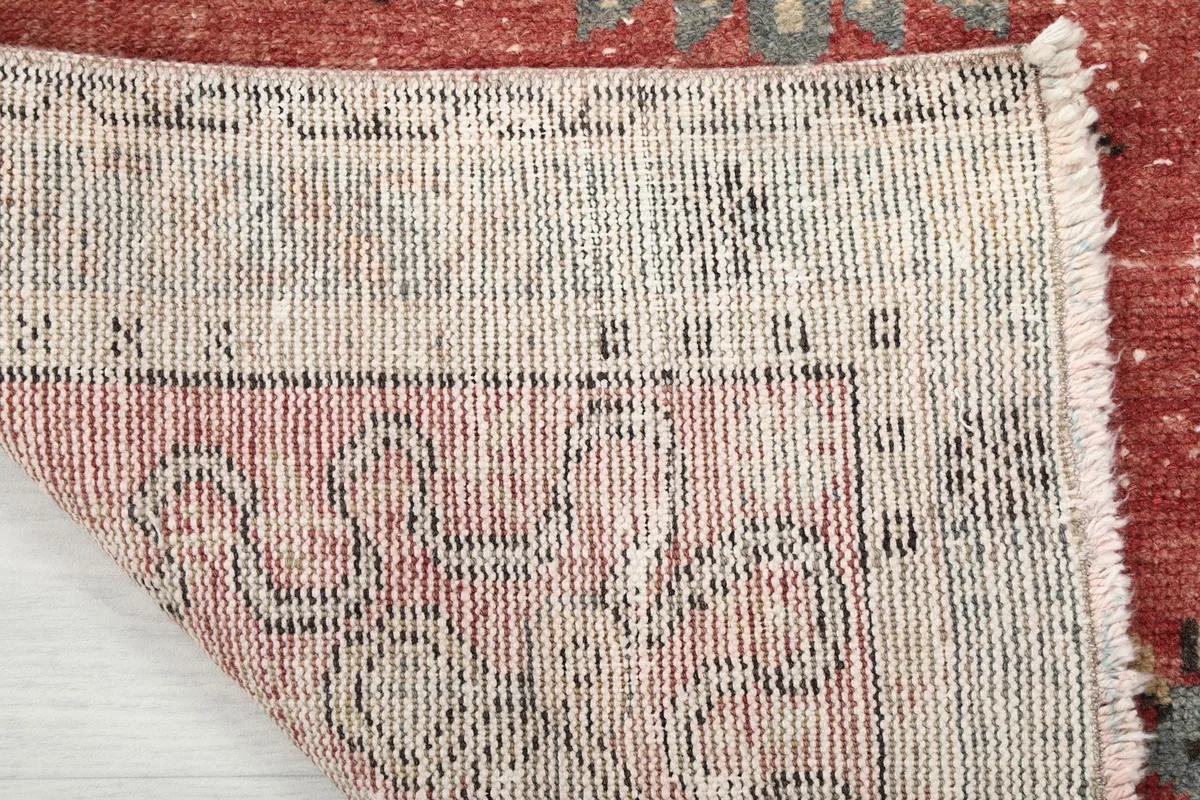 Close-up showing the low pile and intricate hand-knotted weave from the back of the rug