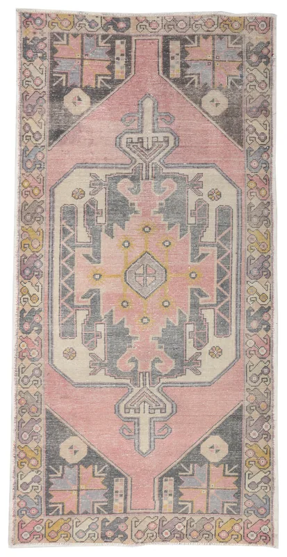 Full top view of the 4'3" x 8'6" pink and charcoal geometric vintage Anatolian area rug