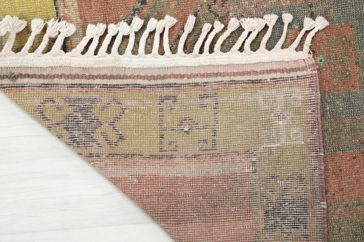 Underside view of the rug, revealing the cotton foundation and hand-knotting craftsmanship.