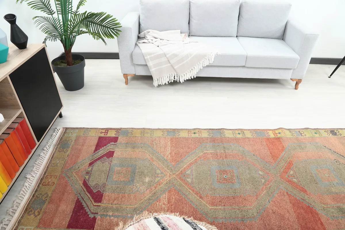 Overhead view of the vintage rust runner rug in a room, highlighting its full design.