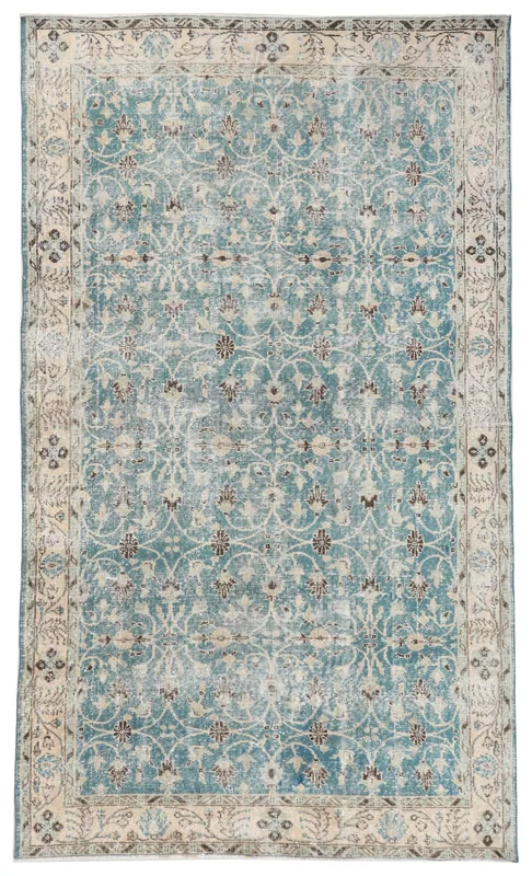 Top view of a blue vintage Anatolian rug with floral patterns and a beige border