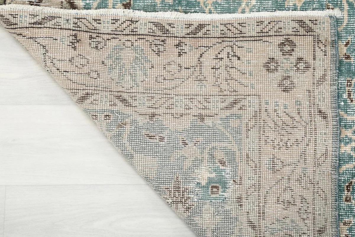 Underside view of the rug, revealing the hand-knotted cotton foundation and weave