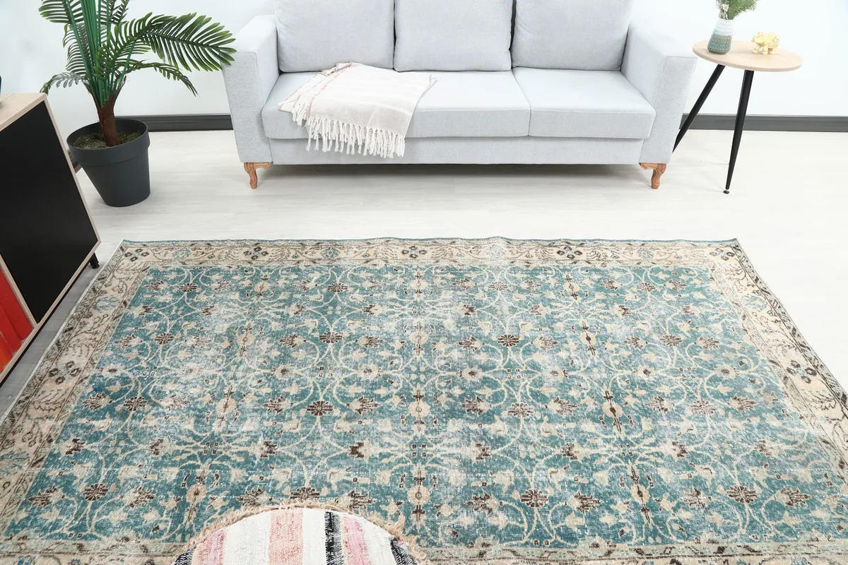 Overhead view of the blue rug in a room, showcasing its full design and colors