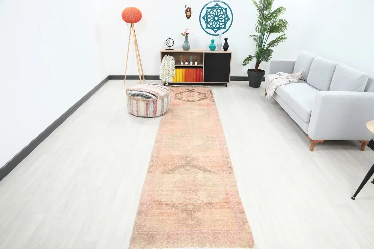 Runner rug in a modern hallway setting, showing its length and color next to a sofa and decor.