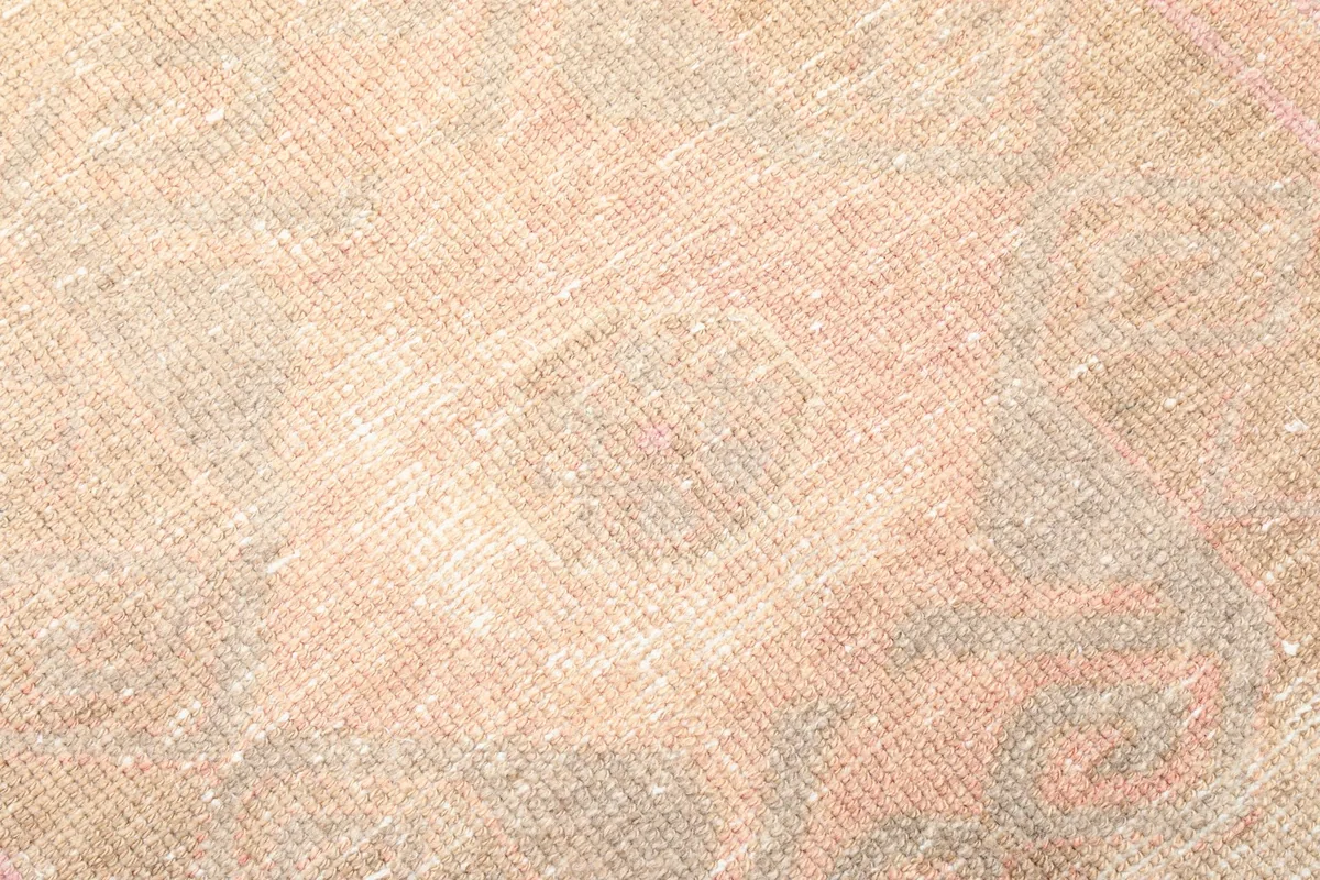 Close-up detail of the low wool pile, showing the hand-knotted texture and color blend.
