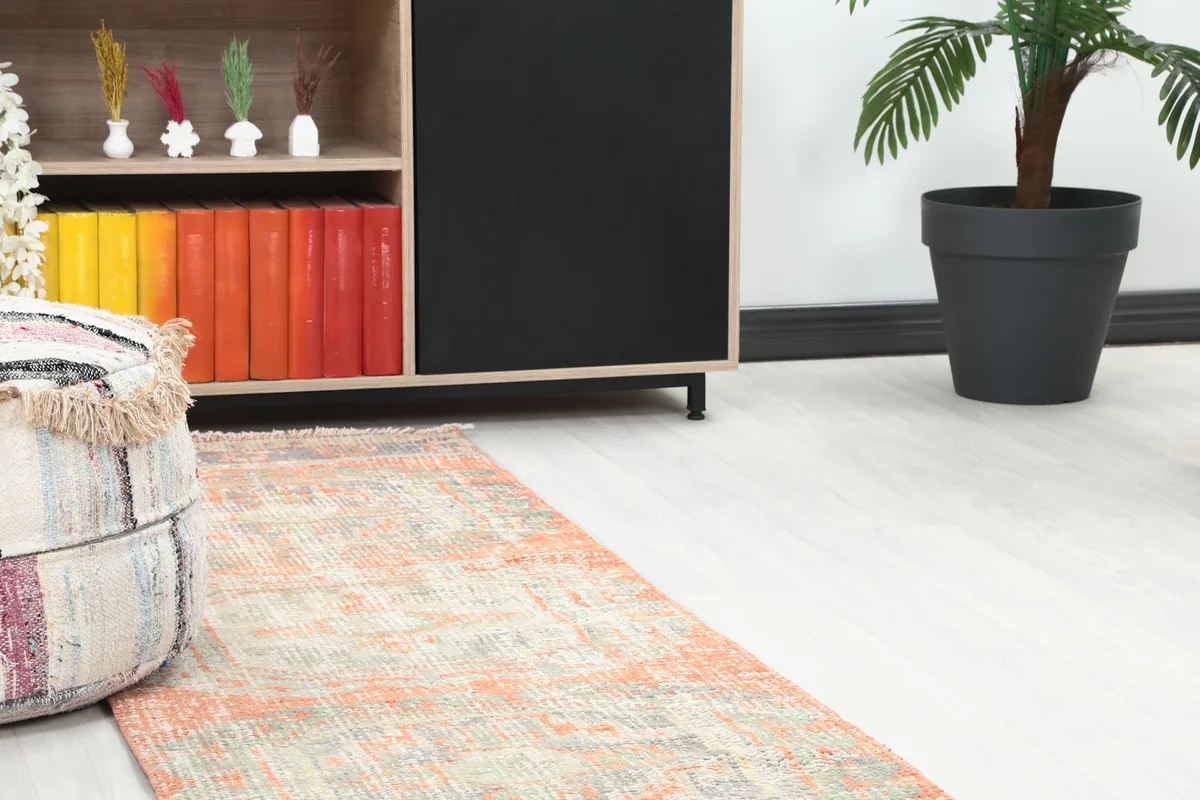 Close-up view of the runner rug's end in a room, showing its blend with surrounding decor elements.