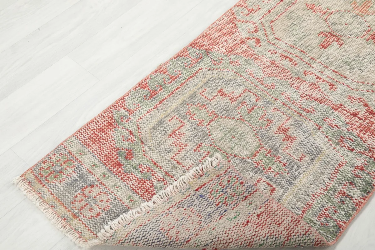 View of the runner rug folded to show its flexibility and the consistent pattern from top to underside.
