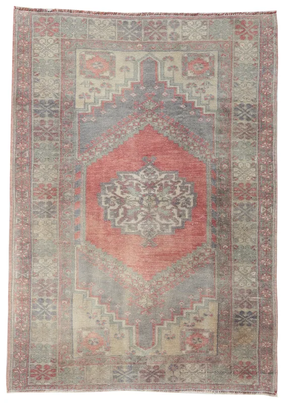 Full top view of the vintage Anatolian wool rug on a white background, displaying its rose, gray, and beige colors.