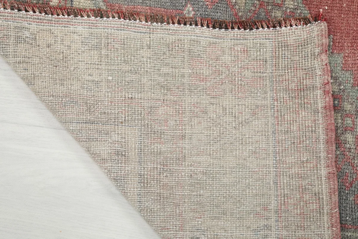 Close-up of the rug's cotton foundation, showing the tight knotting and craftsmanship from the back.
