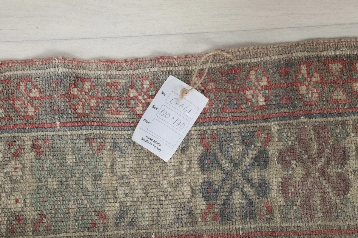 Image showing the product tag attached to the rug's edge, indicating its origin and size.
