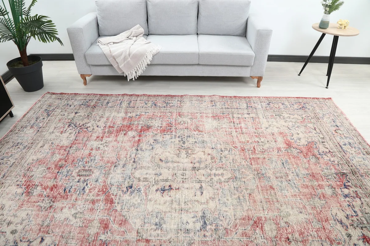 Overhead view of the red and blue vintage rug in a room with a gray sofa
