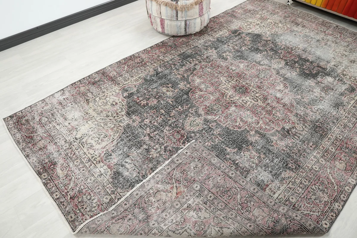 Corner of the rug folded back to reveal the cotton foundation and hand-knotting on the reverse.