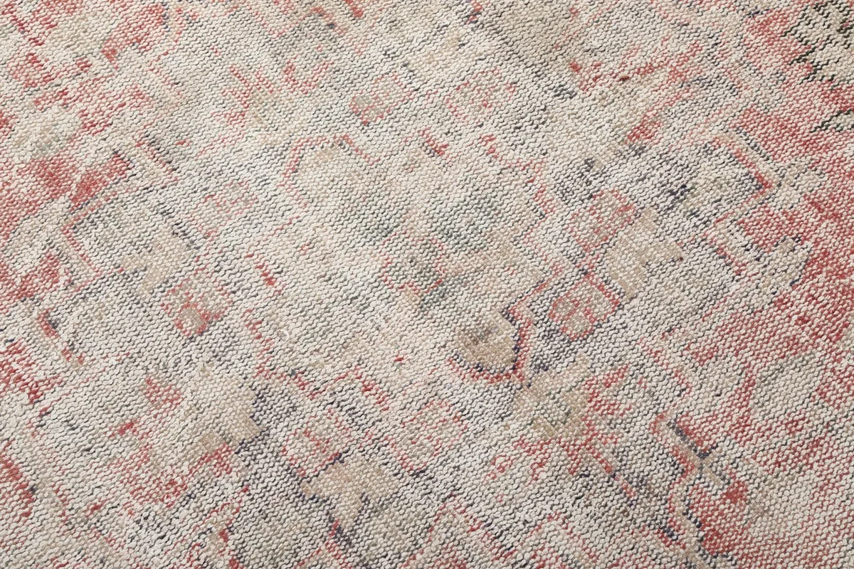 Close-up of the low wool pile, revealing the hand-knotted texture and color blending