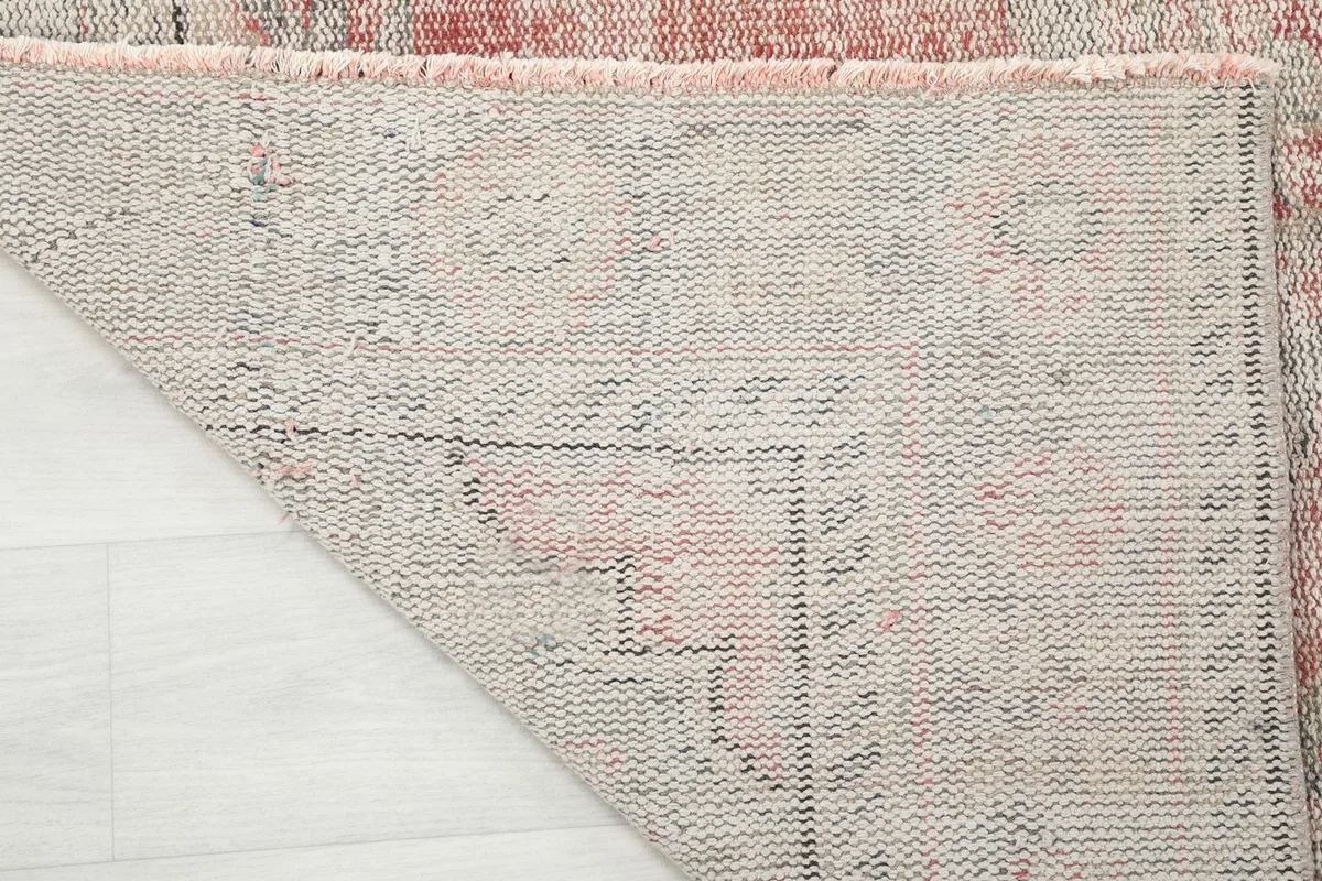 Close-up of the rug's underside, revealing the hand-knotted construction and cotton foundation