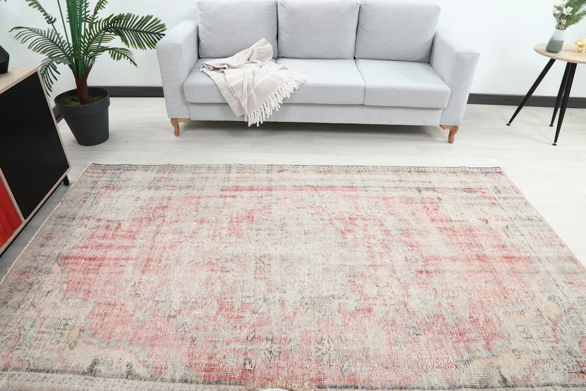 Overhead view of the rug laid out in a room, emphasizing its medium size and overall pattern