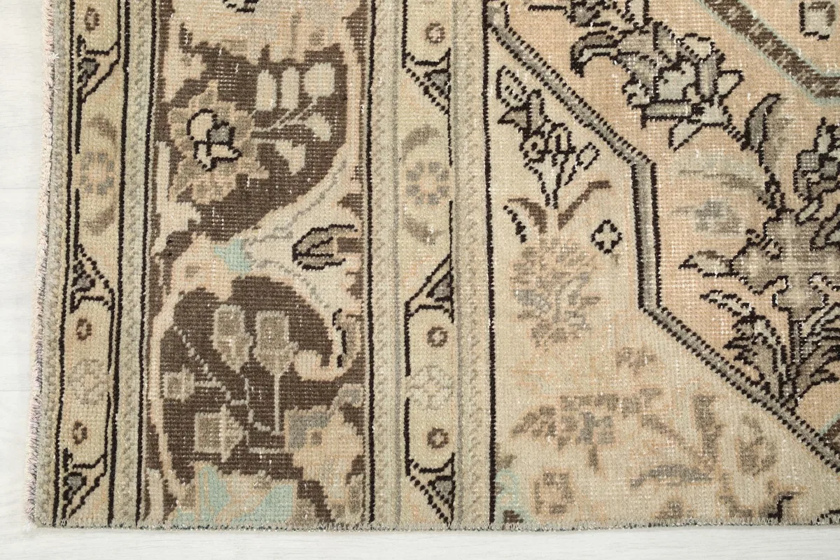 Detailed view of the rug's border and a section of the main field, highlighting the distinct patterns