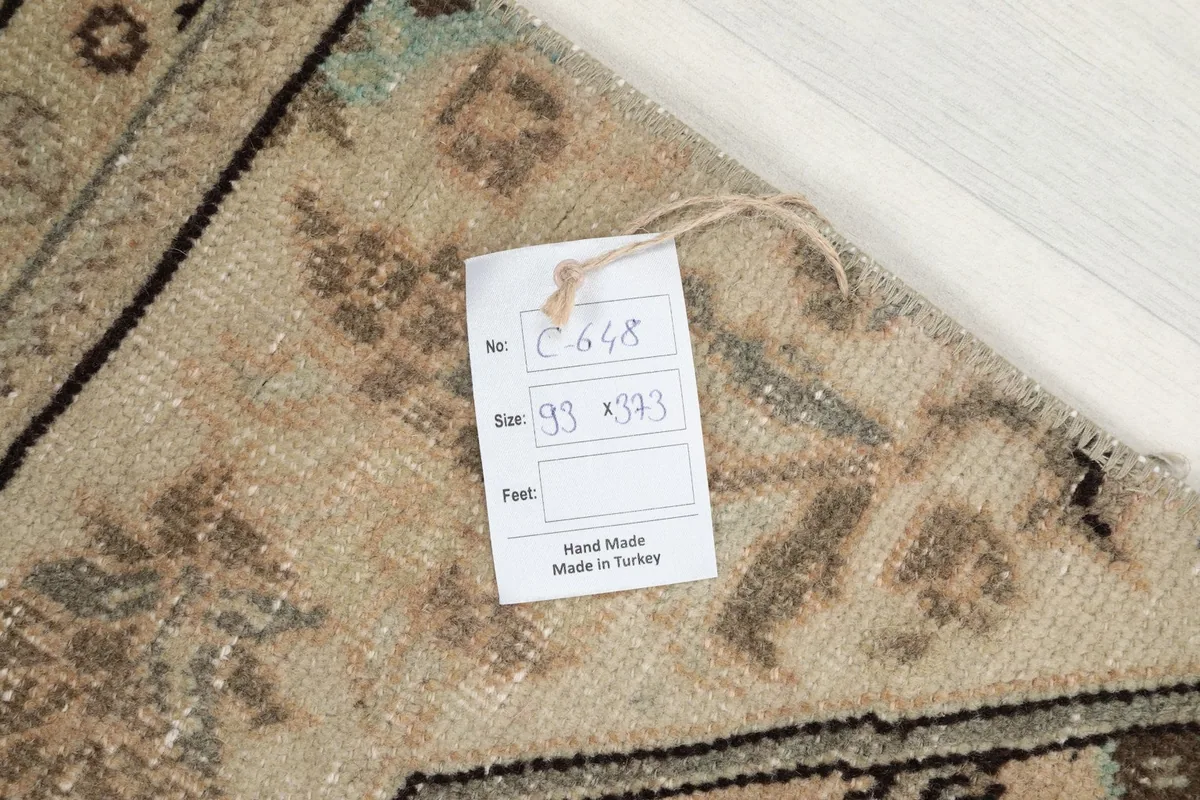 Information tag on the back of the rug, confirming its handmade origin and dimensions