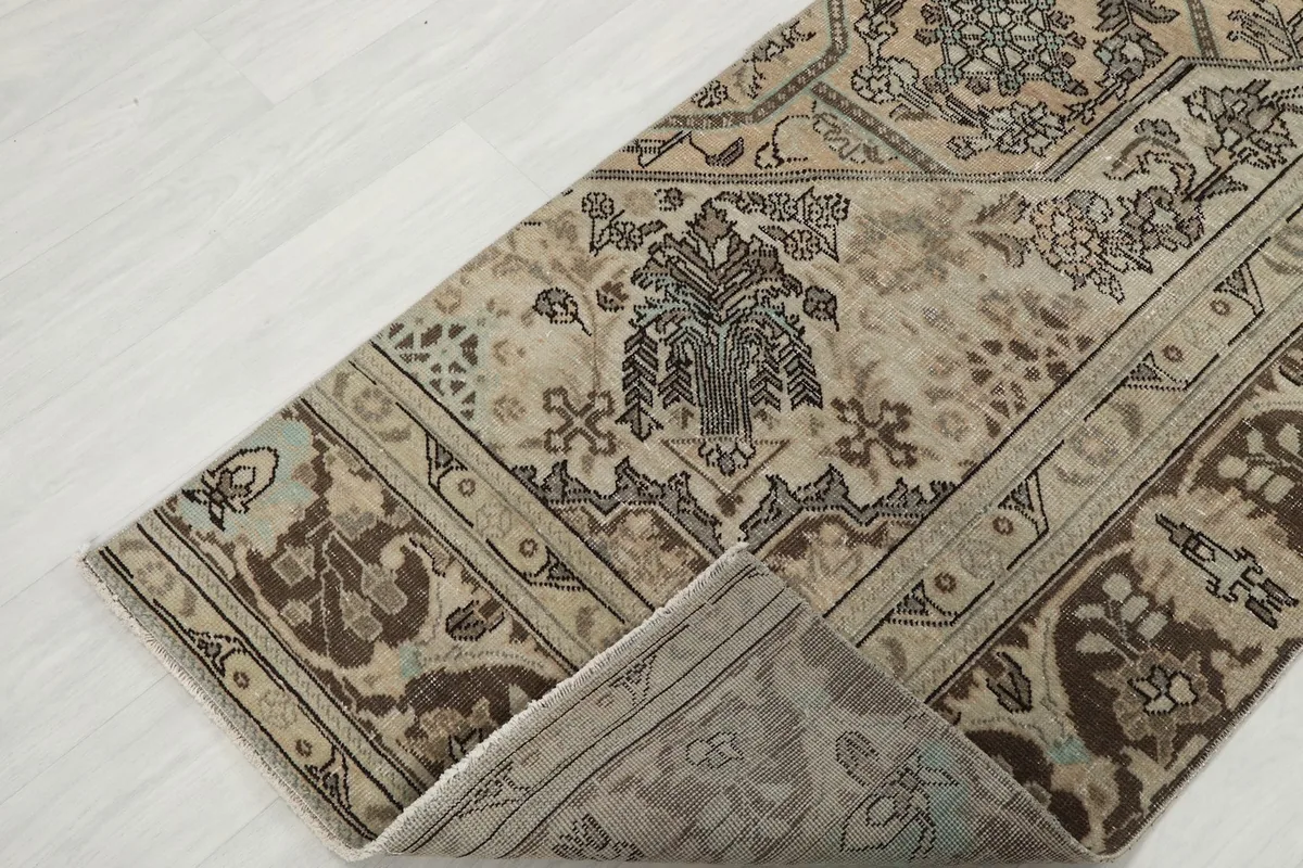 Folded corner of the runner rug revealing the thickness and texture of the wool pile