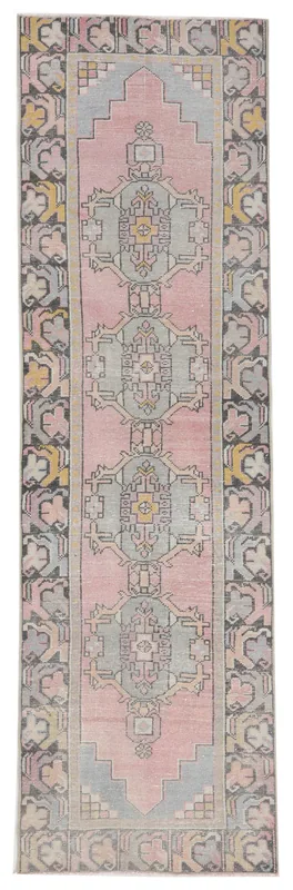 Full overhead view of the 2'7" x 9'1" pink and gray geometric Anatolian runner on a white background.