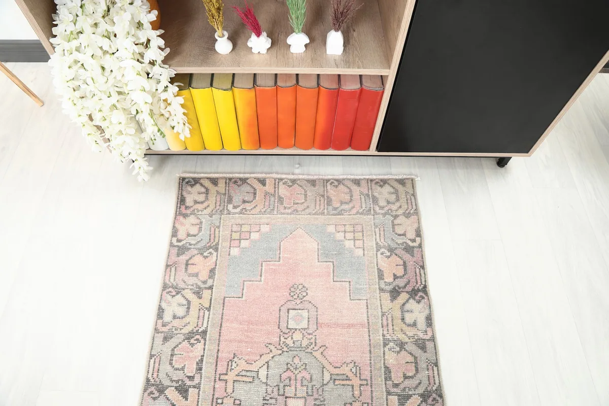 Close-up overhead angle of one end of the runner rug, highlighting the pink and gray geometric patterns.