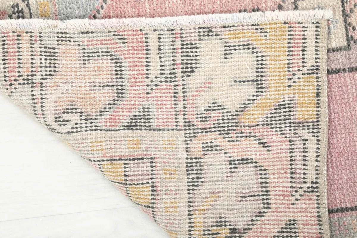 Underside view of the hand-knotted cotton foundation and the back of the wool pile.