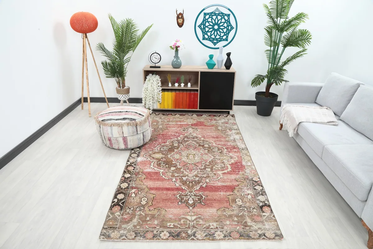 Vintage Anatolian rug in a living room setting with a light gray sofa and modern decor