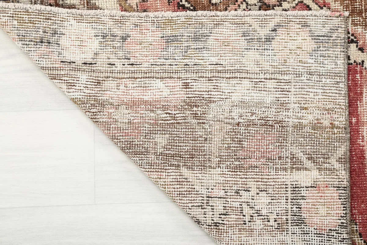 Underside of the hand-knotted rug, revealing the cotton foundation and knotting structure