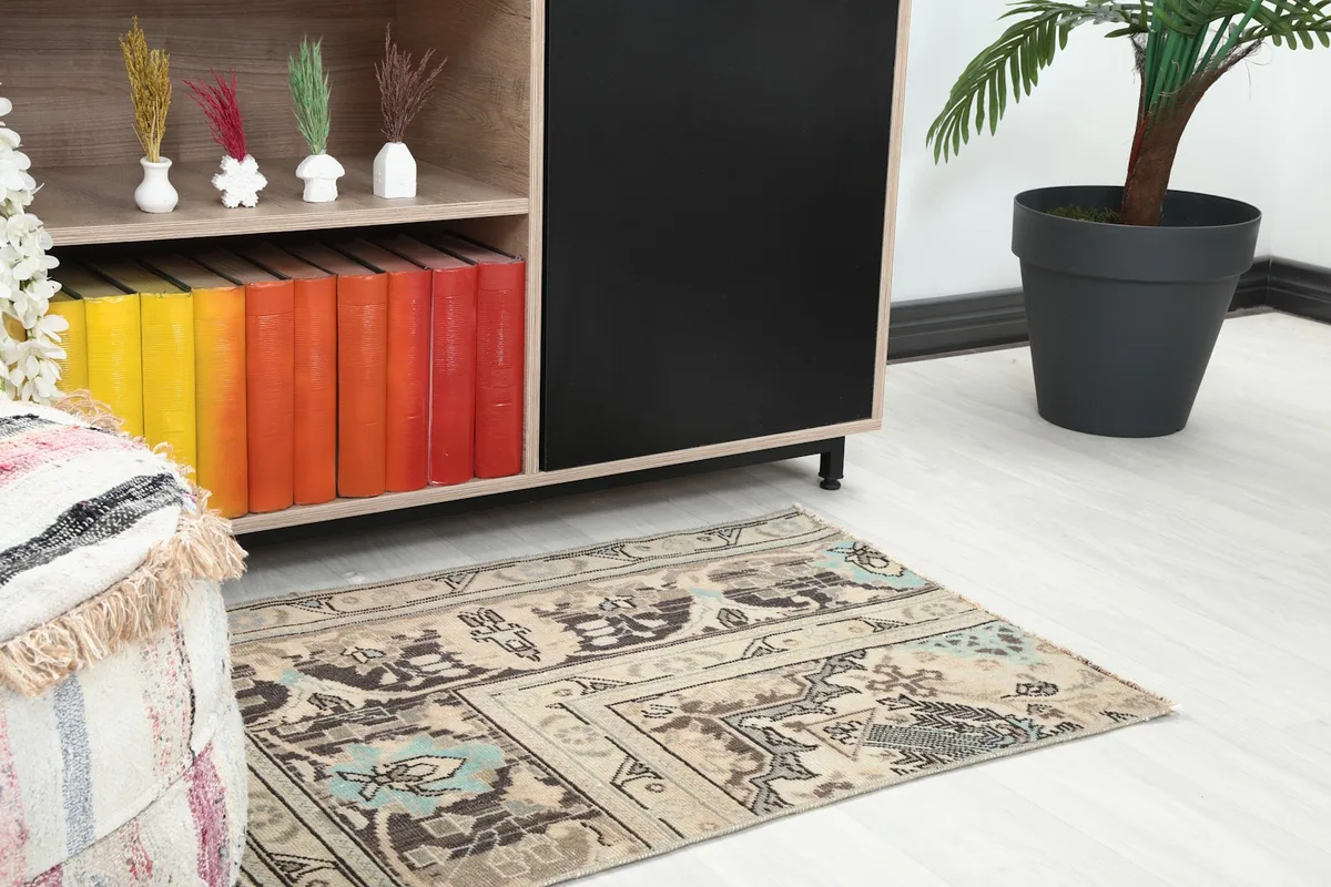 Close-up of the rug in a room, showing its placement next to a cabinet