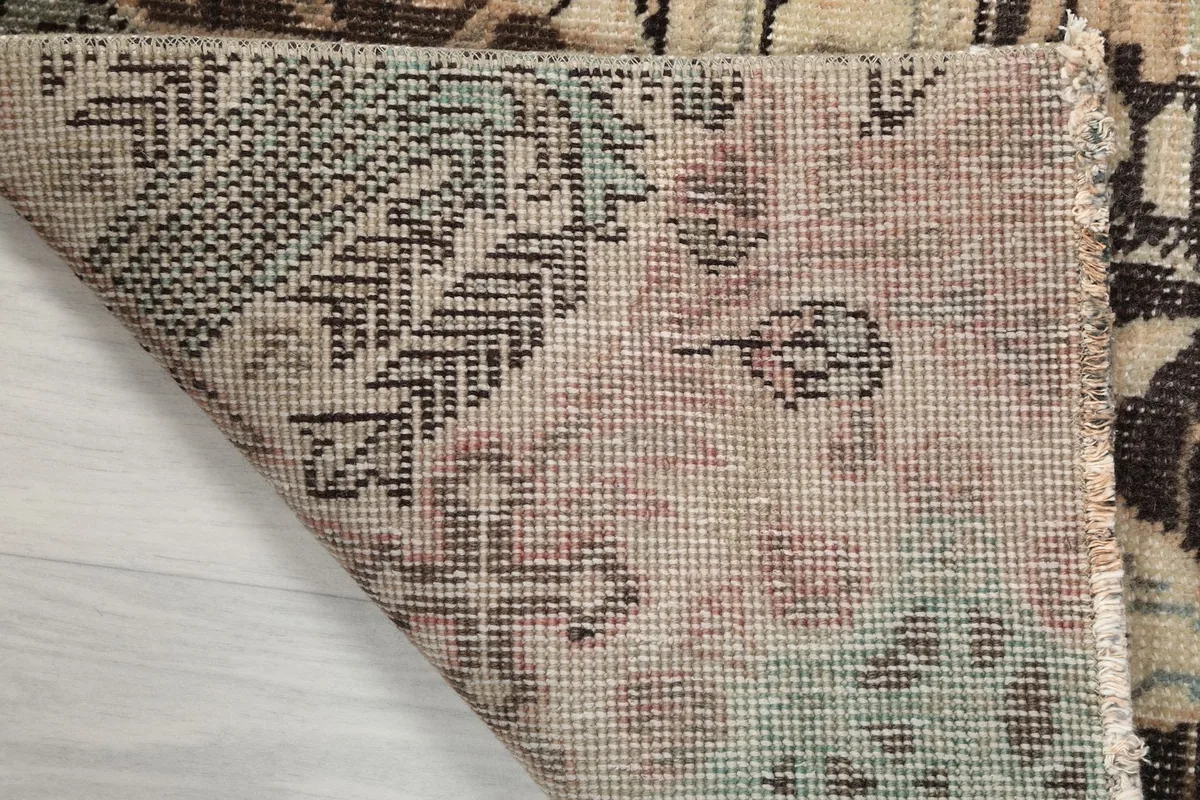 Close-up of the rug's back side, displaying the tight knotting of the wool on cotton