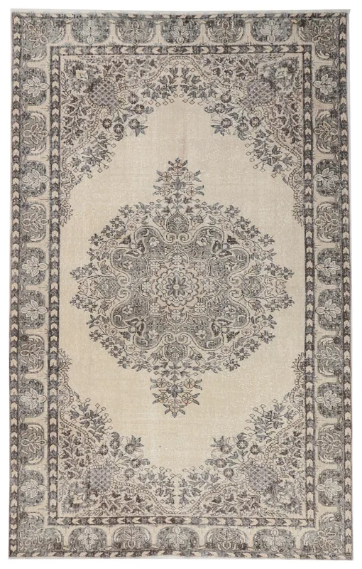 Full overhead view of the ivory and gray vintage Anatolian rug with a central medallion