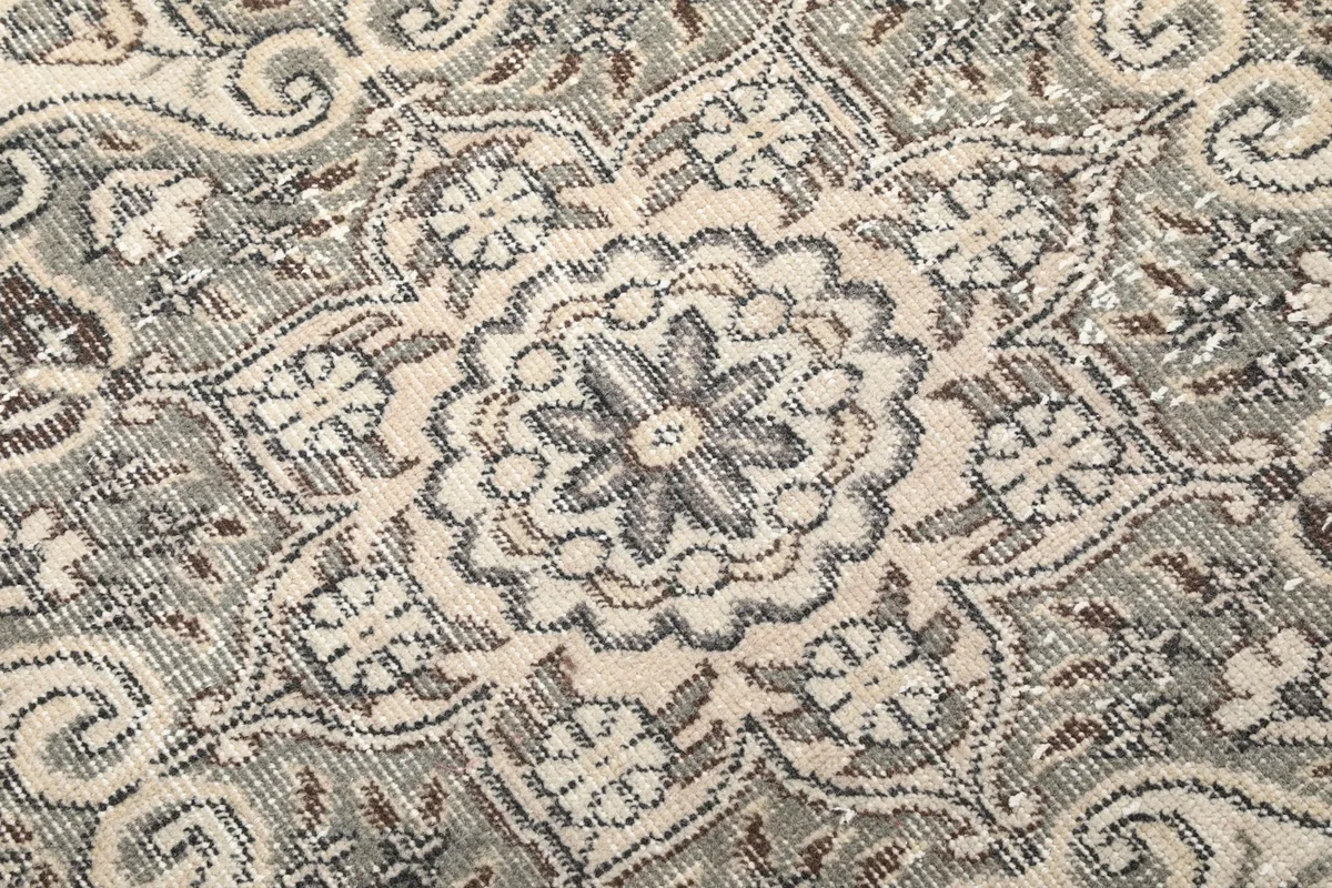 Extreme close-up of the rug pile, revealing the varied texture and distressed appearance of the wool