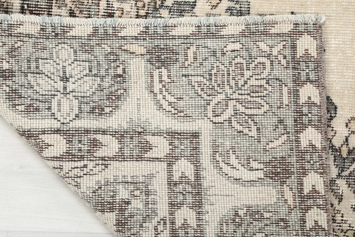 View of the back of the rug, showing the hand-knotted construction and cotton foundation