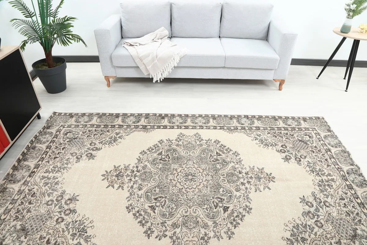 Overhead view of the rug in a room, showing the central medallion and surrounding floral motifs