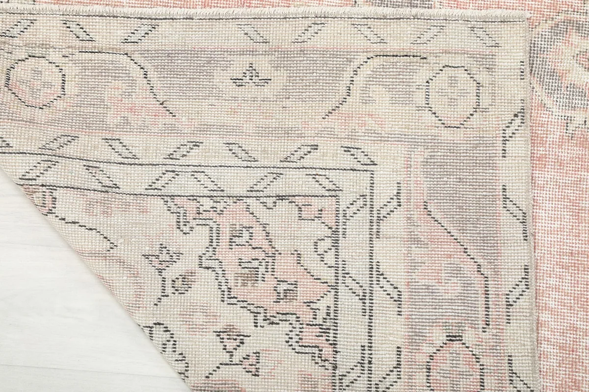 View of the reverse side of the hand-knotted vintage rug, showing the knots and cotton foundation.