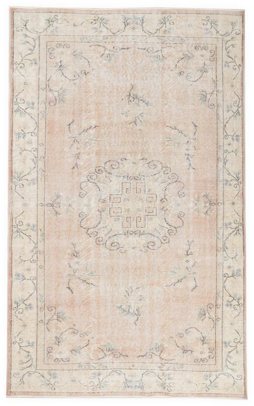 Full overhead view of the 5'7" x 8'10" rose and beige vintage Anatolian rug with a central medallion.